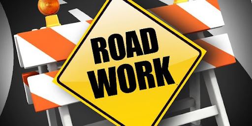 Yellow Road Work Sign on orange and white background