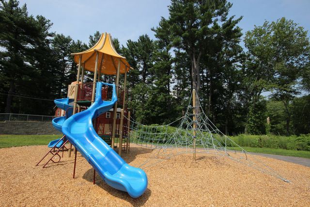 Blue slide attached to jungle gym
